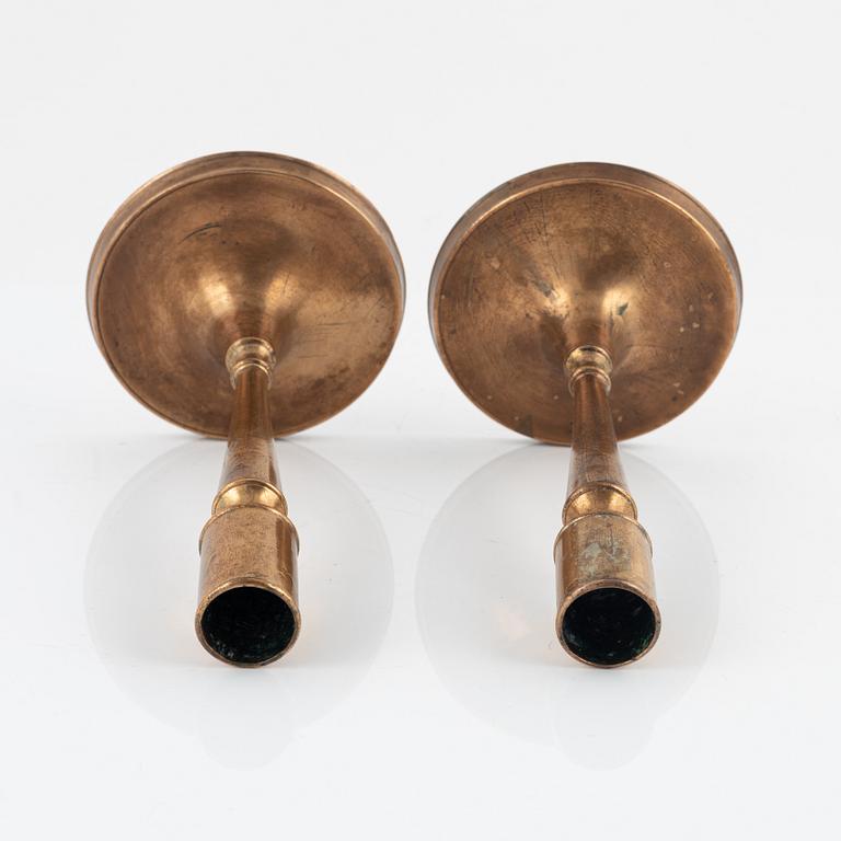 A pair of bronze candlesticks, 18th Century.