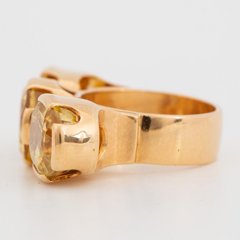 18K gold and yellow sapphire three-stone ring.