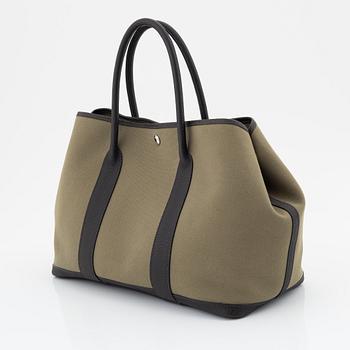 Hermès, a green canvas and brown leather 'Garden Party' bag.