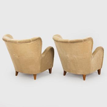 A pair of mid-20th century armchairs.