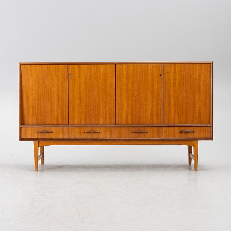 A mid20th century teak-veneered sideboard.
