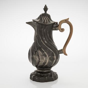 A mid 18th century rococo pewter jug.