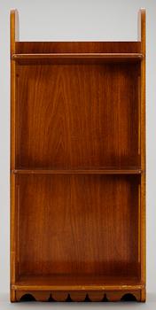 A Josef Frank mahogny shelf by Firma Svenskt Tenn.