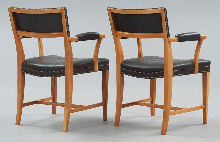 A pair of Josef Frank walnut and black leather armchairs, Svenskt Tenn, model 695.