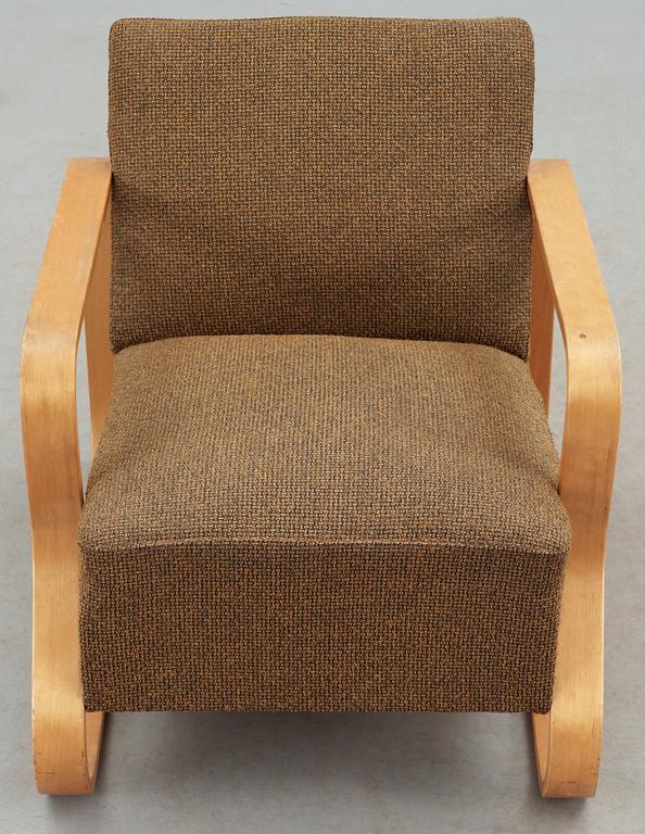 An Alvar Aalto laminated birch 'padded Paimio chair', upholstered in yellow and black fabric.