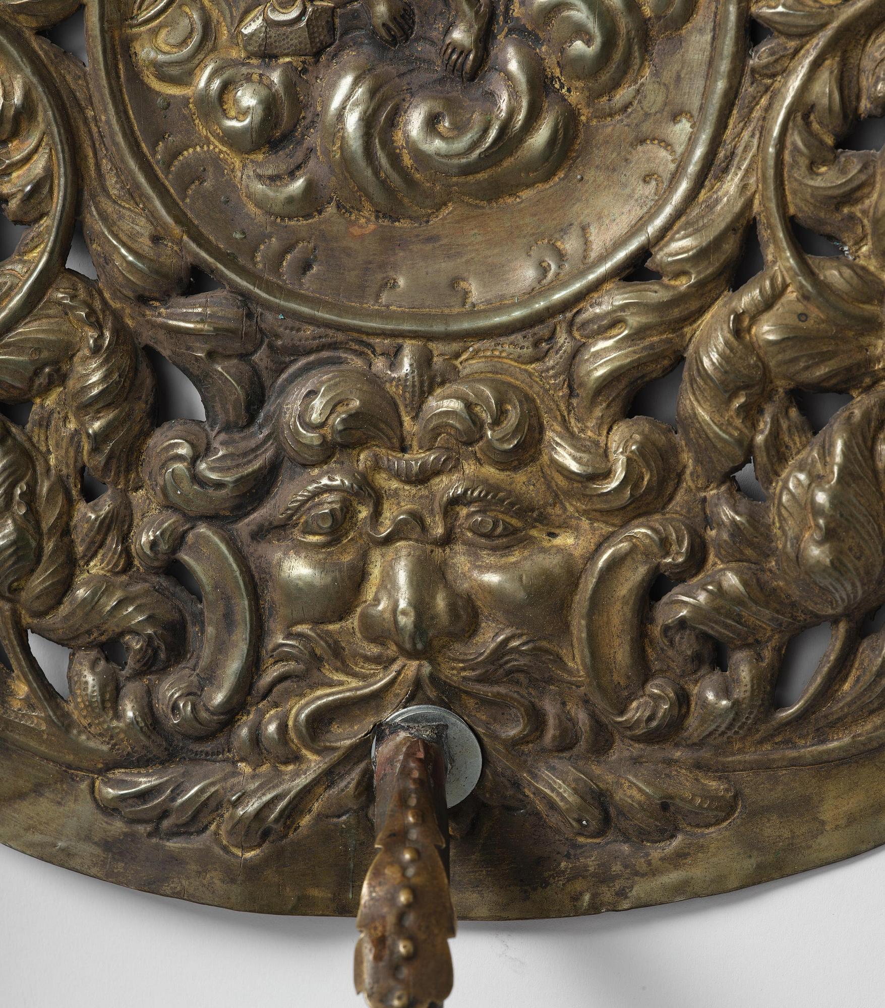 A set of four Swedish Baroque repoussé silvered brass reflector one-branch reflector plates, ca 1690-1700.