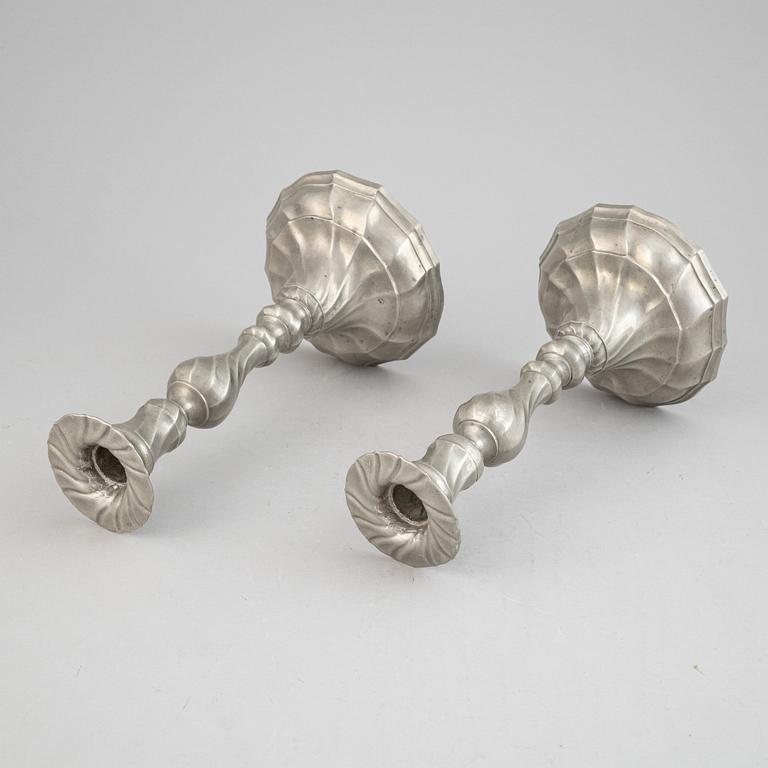 A pair of rococo style pewter candlesticks, 19th Century.