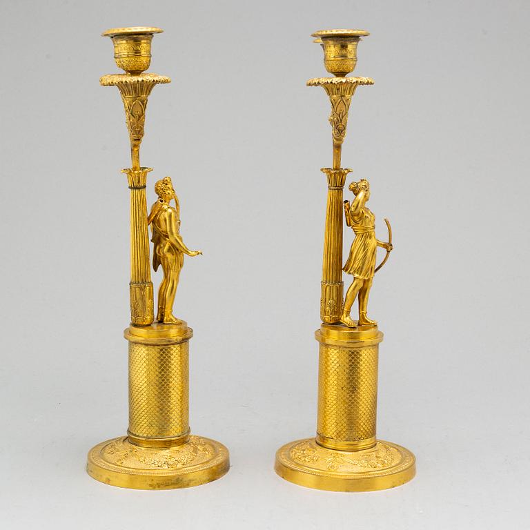 A pair of French Empire two-light gilt bronze candelabra, early 19th century.