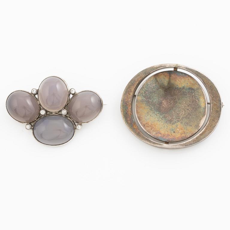 Two brooches, silver with chalcedony and white stones, SE Högberg, Gothenburg 1964 and H Strömdahl, Stockholm.