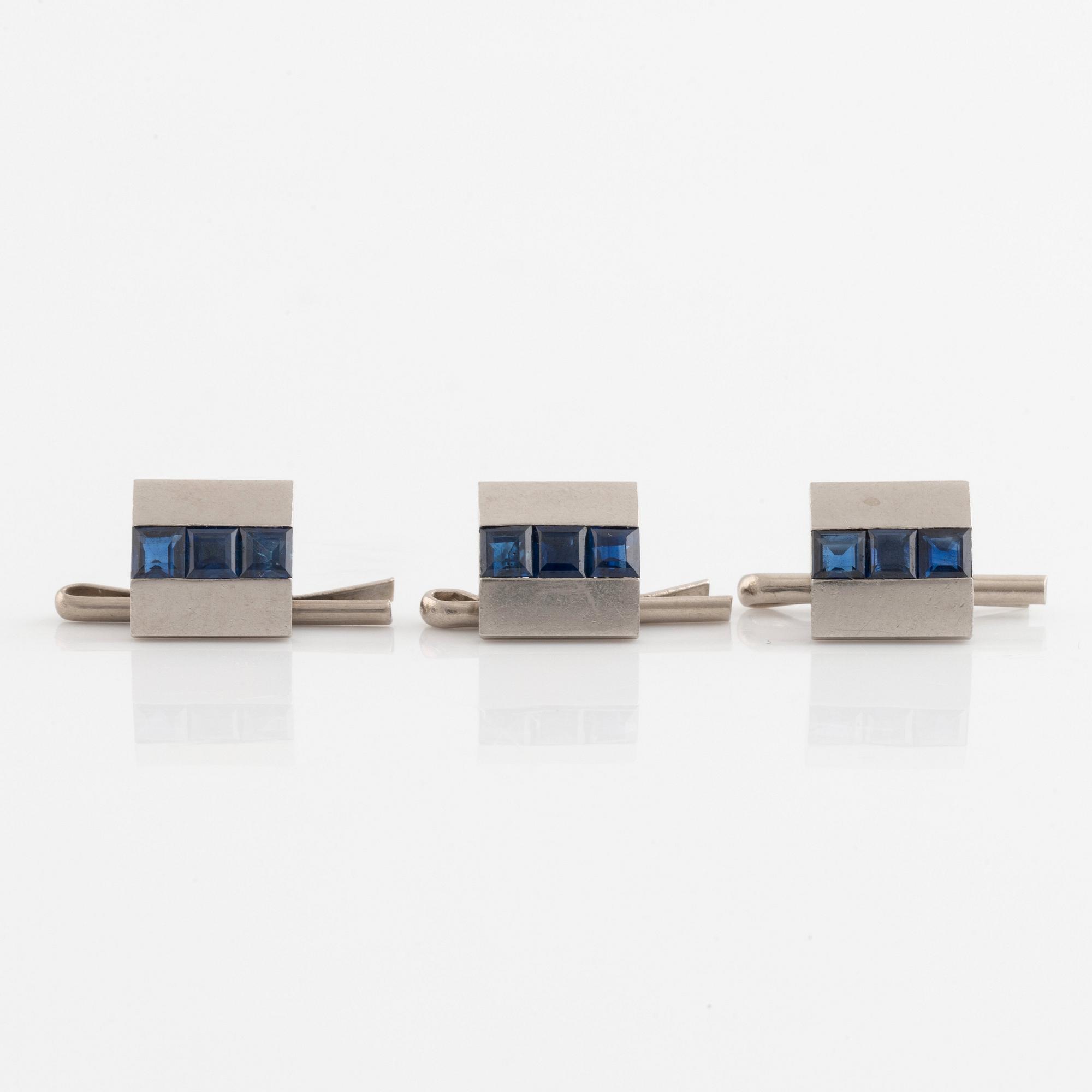 Boucheron, three shirt buttons, platinum and step cut sapphires.