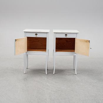 A pair of painted bedside tables with marble tops, 1920's.
