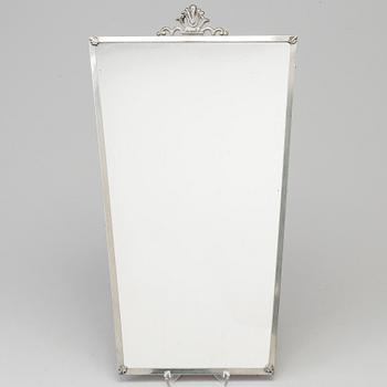 A Swedish pewter mirror dated 1935.