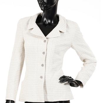 CHANEL, a white bouclé jacket.