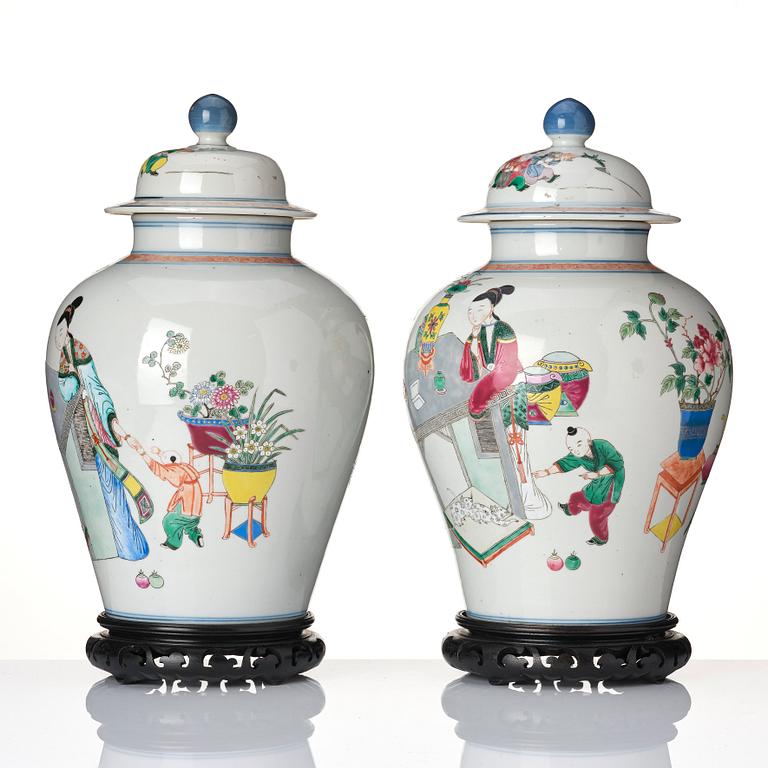 A pair of famille rose 'ladies and boys' vases with covers, late Qing dynasty.