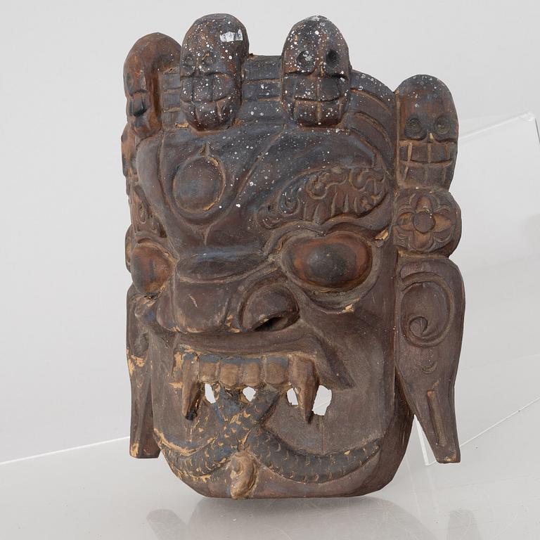 Four Tibetan/South East Asian wooden decorations, 20th century.