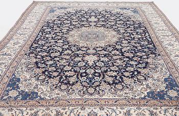 A Nain part silk carpet, c. 535 x 340 cm.