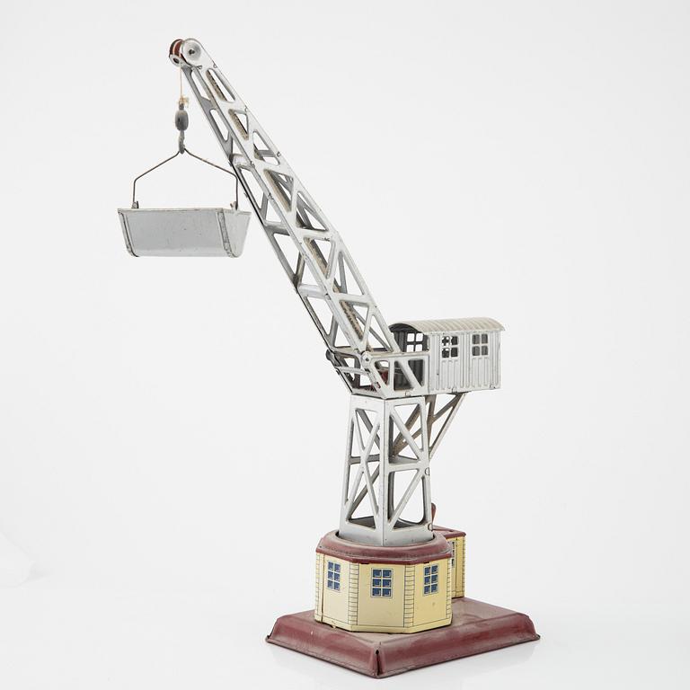 Three tin toys including a Gescha tank, Germany, mid 20th century.