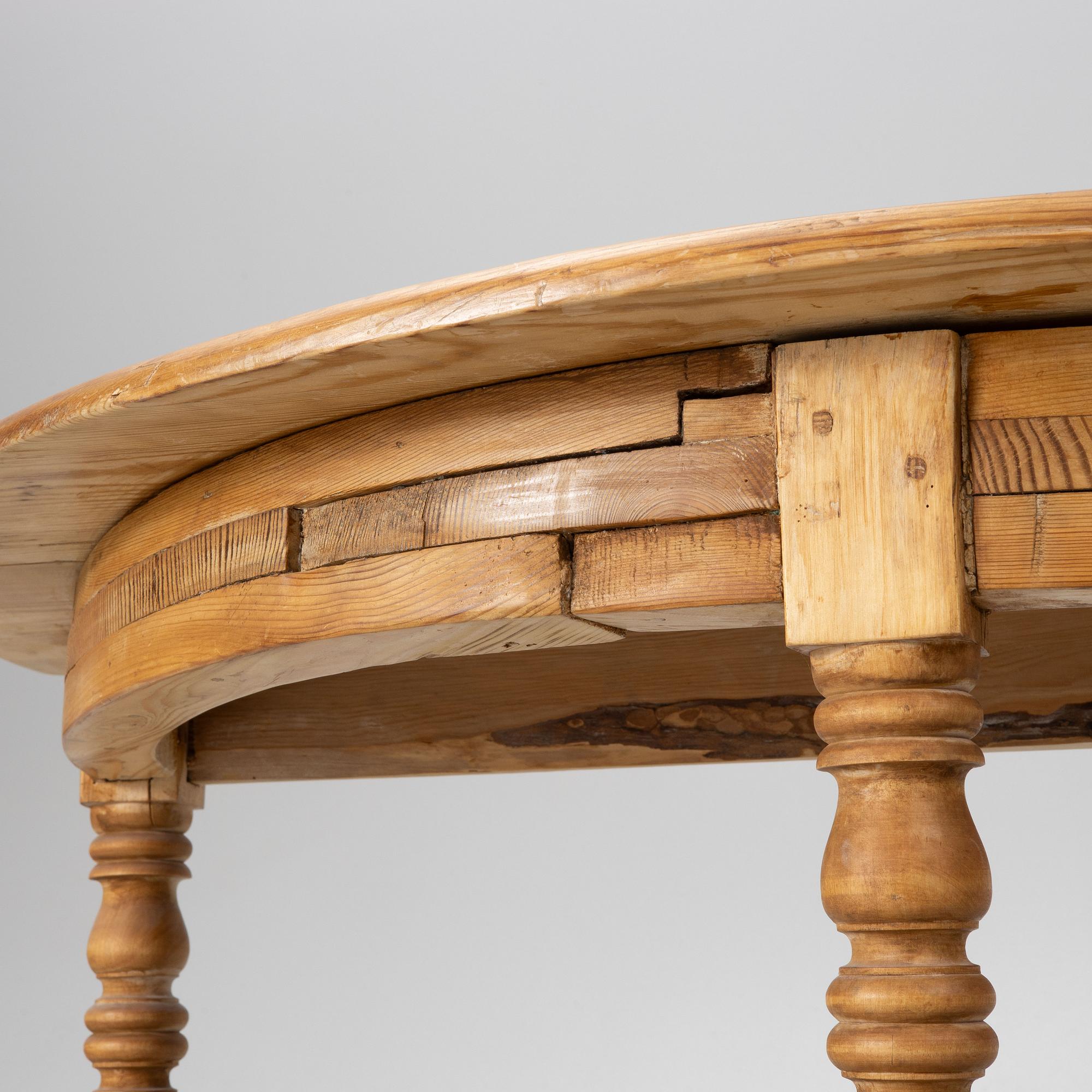 A round pine dining table/a pair of crescent shaped tables, Sweden, 19th century.