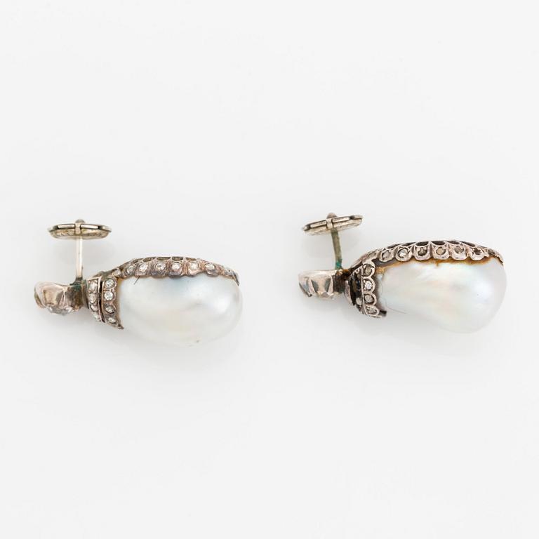 A pair of silver and pearl earrings set with old- and rose-cut diamonds.