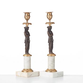 A pair of late Gustavian circa 1800 white marble and bronze candlesticks.