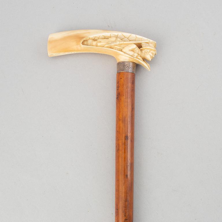 A wooden cane with bone handle, aroudn the year 1900.