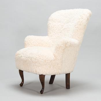 A contemporary sheepskin upholstered lounge chair, ABC collection.