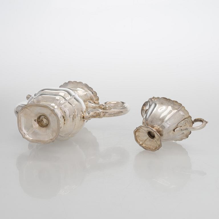 A silver coffee pot, sugar bowl, cream jug, and sugar tongs, Finland 1926-49.