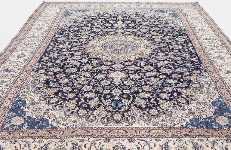 A Nain part silk carpet, c. 535 x 340 cm.
