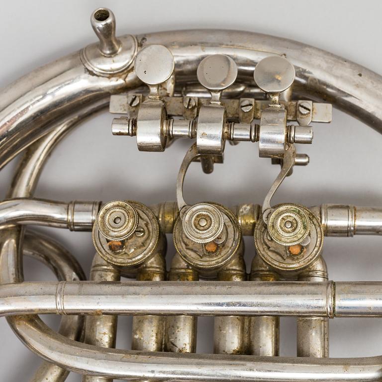 A metal french horn, probably 1936.