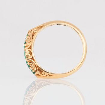 A ring with five step-cut emeralds.