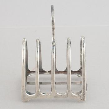 A set of four English silver salt cellars and a toast rack, including Roberts & Belk, Sheffield, England 1898.