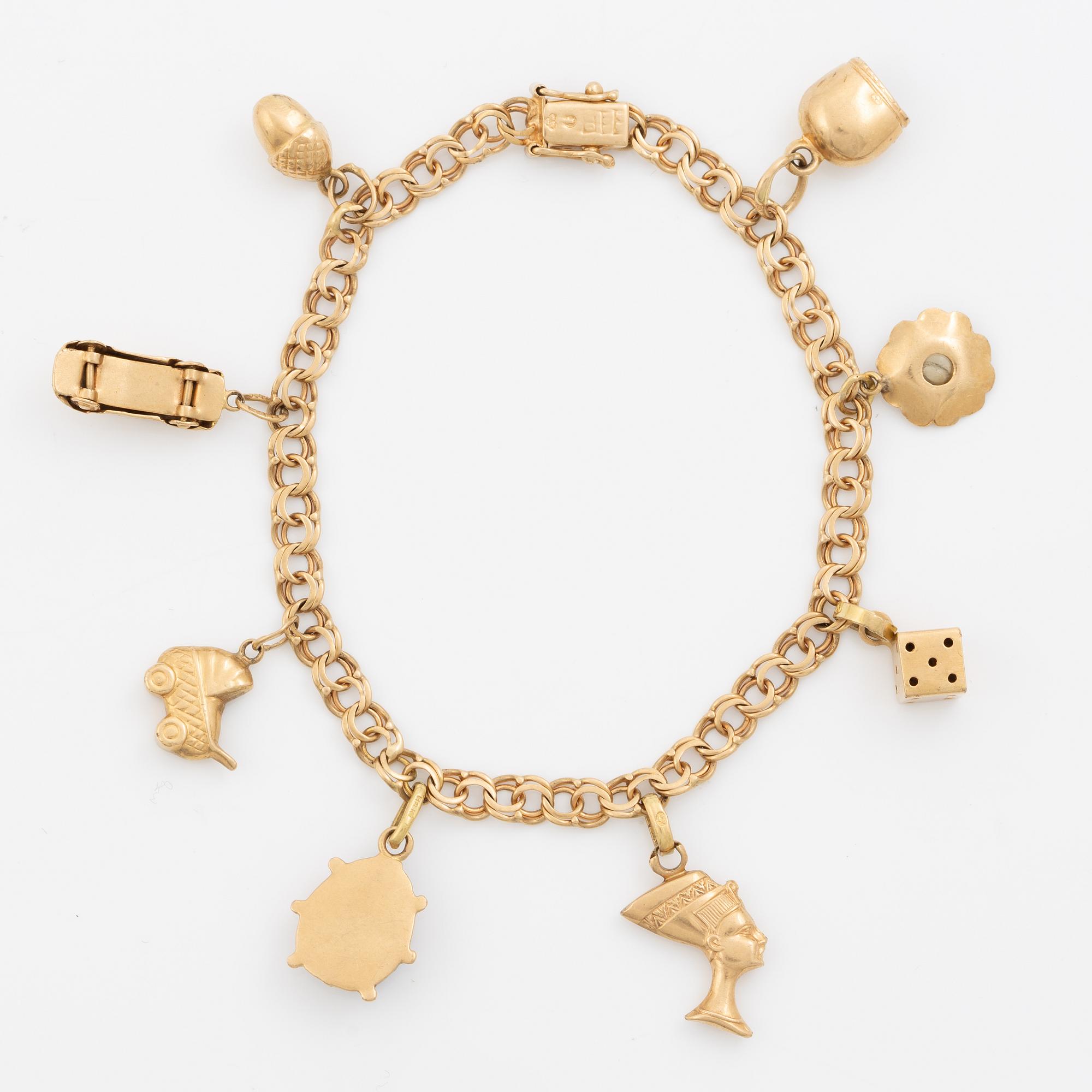 Bracelet, 18K gold bismarck link. With charms.