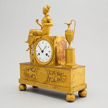 A first half of the 19th century Empire bronze mantle clock.