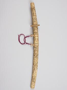 A elaborately sculptured Japanese ceremonial sword, Meiji (1868-1912), with an older blade originally from a long sword.