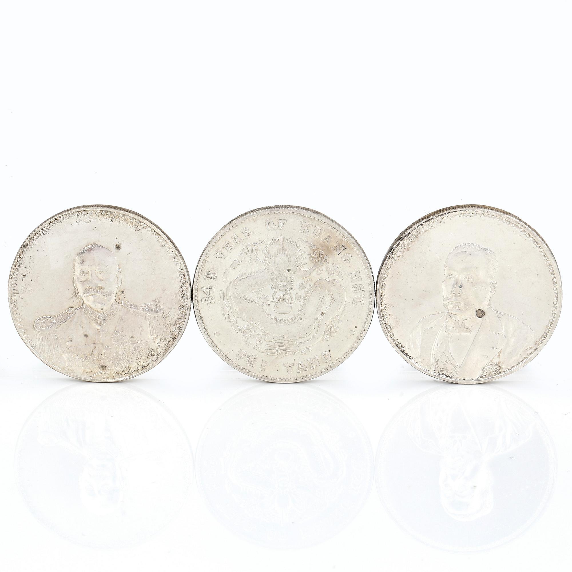 A group of three Chinese silver coins, Guangxu (1908), and two from the Republic era (1912-1949).