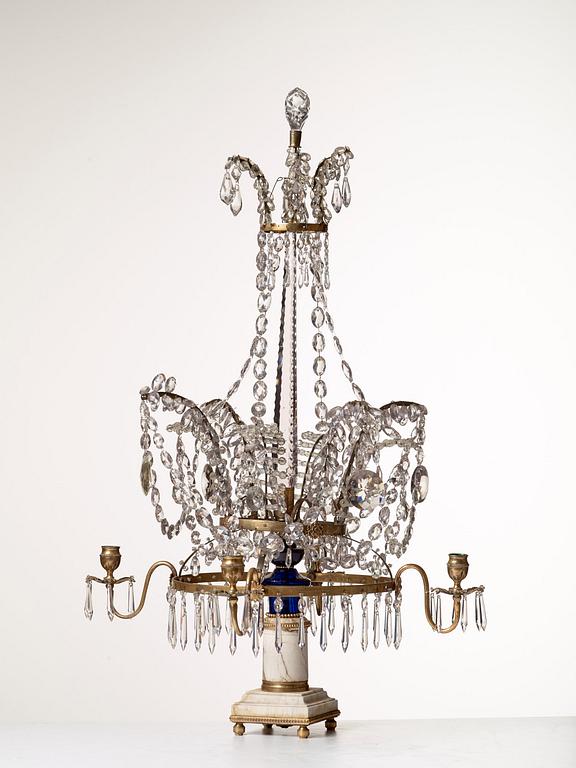 A presumably Russian Louis XVI gilt brass and cut glass four-light table girandole.