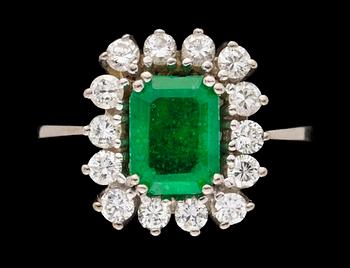 673. A gold, emerald and diamond ring.
