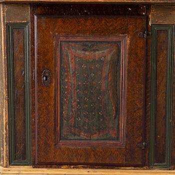A corner cupboard, dated 1779.