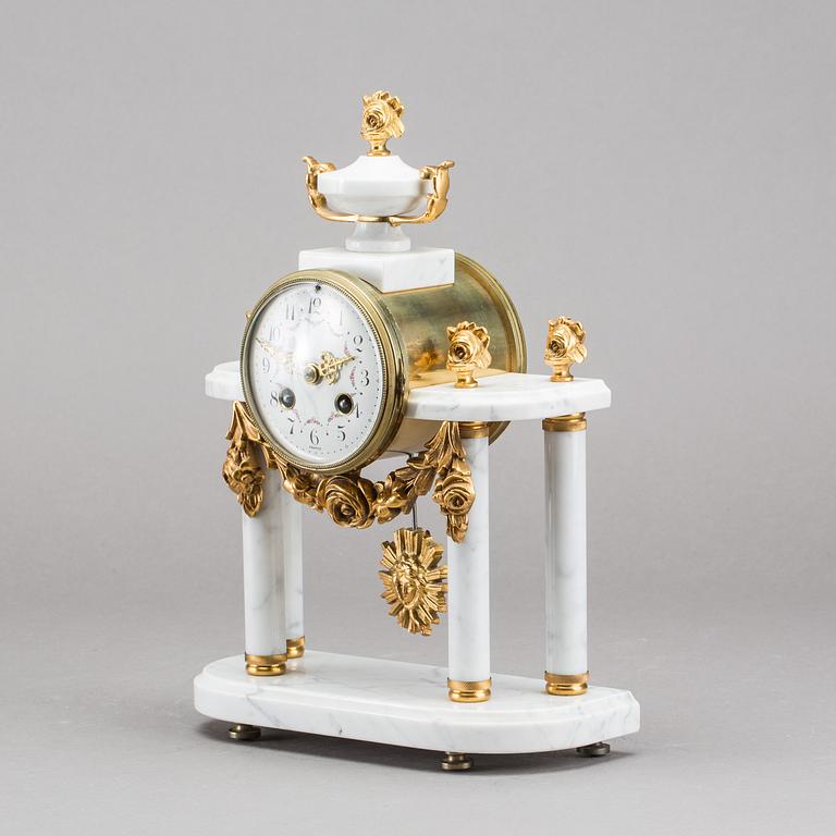 A Louis XVI-style mantle clock.