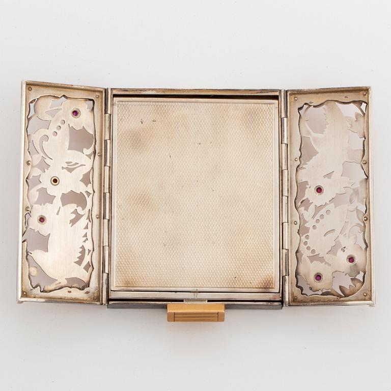 A silver and silver-gilt powder case set with cabochon-cut rubies, possibly Boucheron.