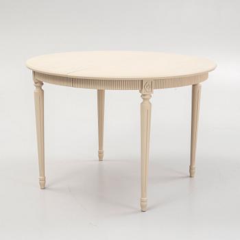 A Gustavian style dining table and eight chairs, late 20th Century.