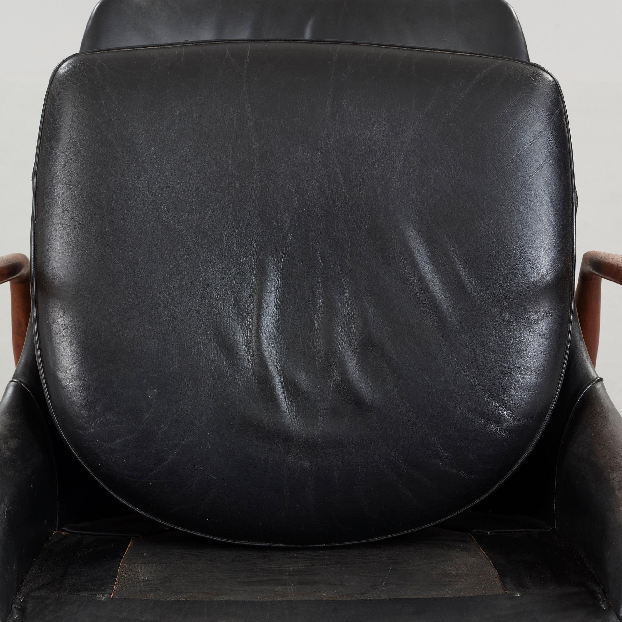 Ib Kofod-Larsen, a 'Seal' teak and black leather armchair, Olof Persson Möbler, Jönköping, Sweden 1950's-60's.
