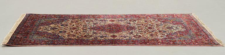 A CARPET, a semi-antique silk Kashan, ca 208,5 x 130 cm.