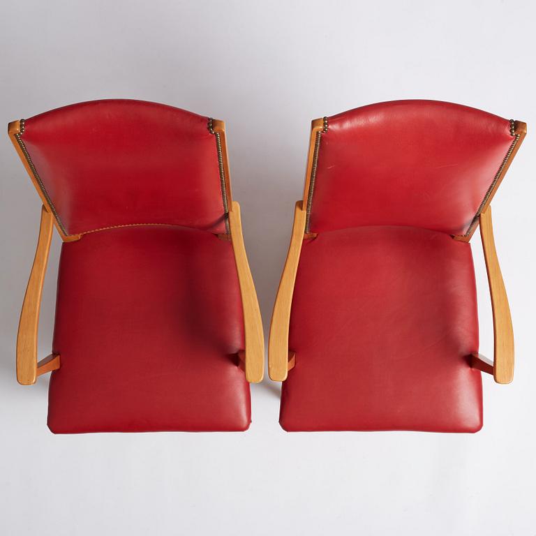 Josef Frank, a pair of walnut and red leather easy chairs, Svenskt Tenn, Sweden 1940-60s.