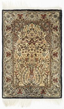 An oriental silk rug, c. 93 x 63 cm.