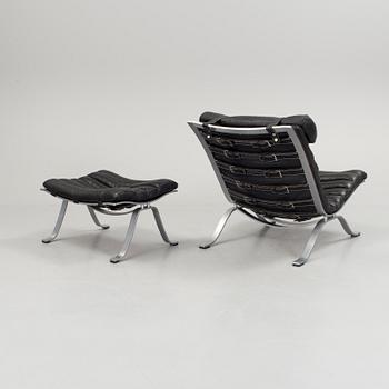 A black leather "Ari" easy chair with foot stool by Arne Norell for Norell möbler.