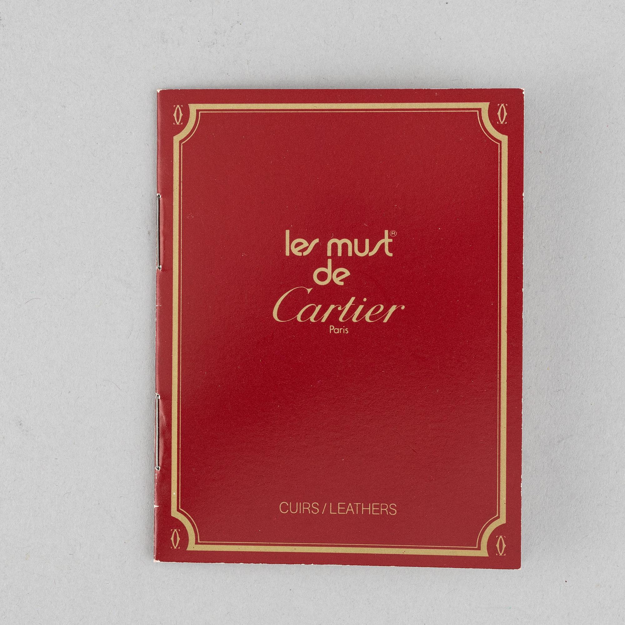 Cartier, a red suede clutch.