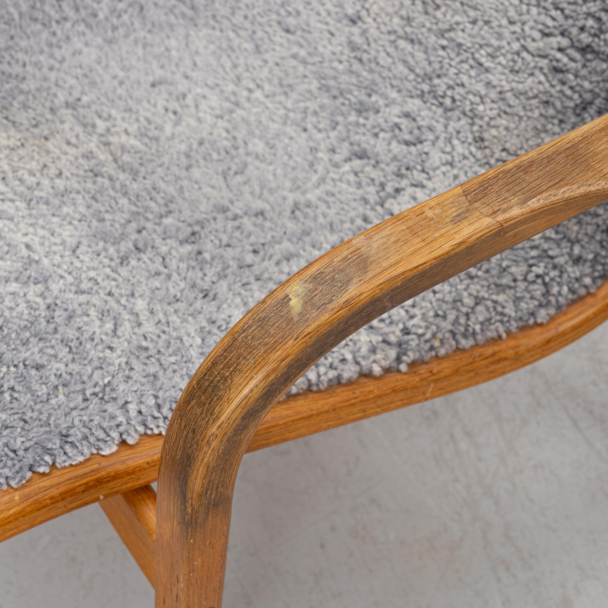 Yngve Ekström, a 'Lamino' armchair with ottoman and sidetable, Swedese, Sweden, 21st century.