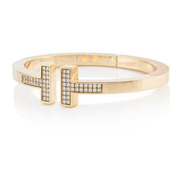 527. An 18K gold Tiffany & Co bracelet "Tiffany T"  with round brilliant-cut diamonds.