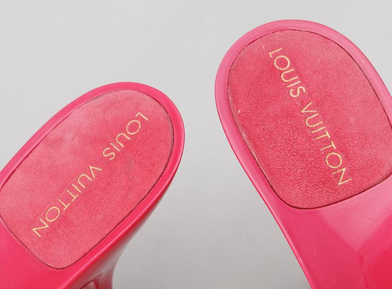 A pair of pink lacquer slip-in by Louis Vuitton.
